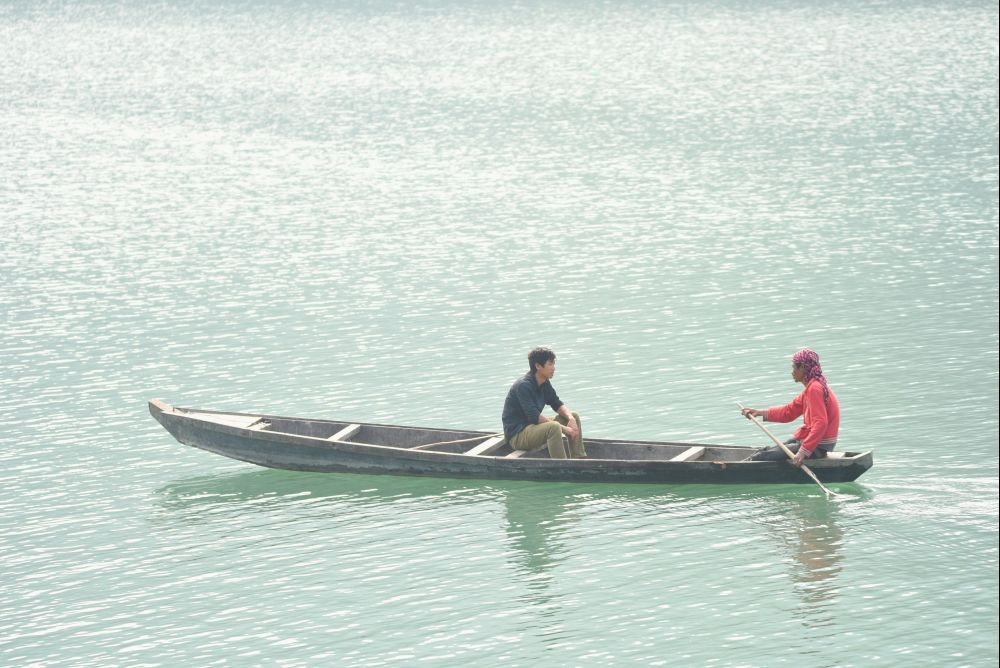 Two men are seen in a rowing boat in the Doyang reservoir under Wokha district in Nagaland. (Morung File Photo by Manen Aier)Y